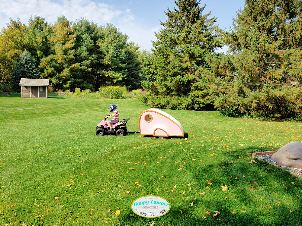 kids 4-wheel pulling a tiny teardrop camper