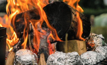 baked potatoes in foil in the campfire