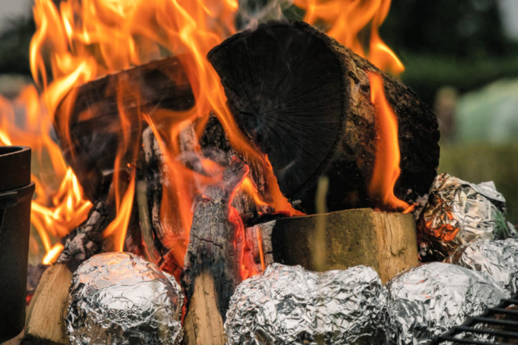 baked potatoes in foil in the campfire