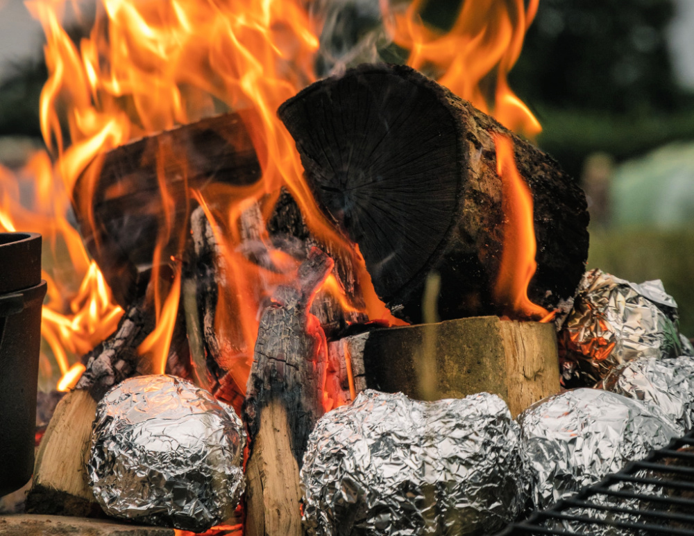 baked potatoes in foil in the campfire